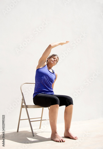 Middle aged senior yoga woman demonstrating asana for aging bodies. 