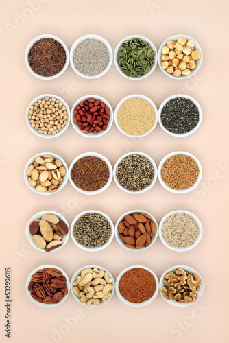 Healthy lipids unsaturated essential fatty acids. Food ingredients containing good fats for a healthy heart and low cholesterol levels with nuts, seeds, legumes and grain. On neutral background.
