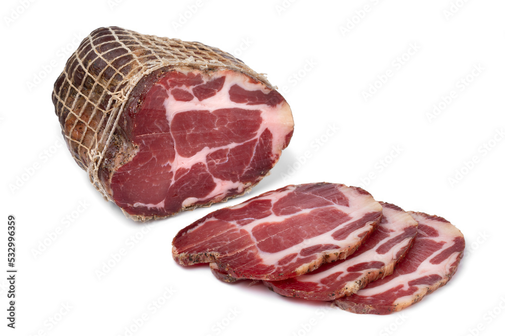 Piece and slices of traditional Croatian dried pork neck, pork collar bacon, isolated on white background
