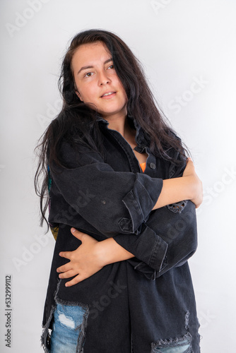 Woman with jacket posing on isolated white background, selective focus shot.