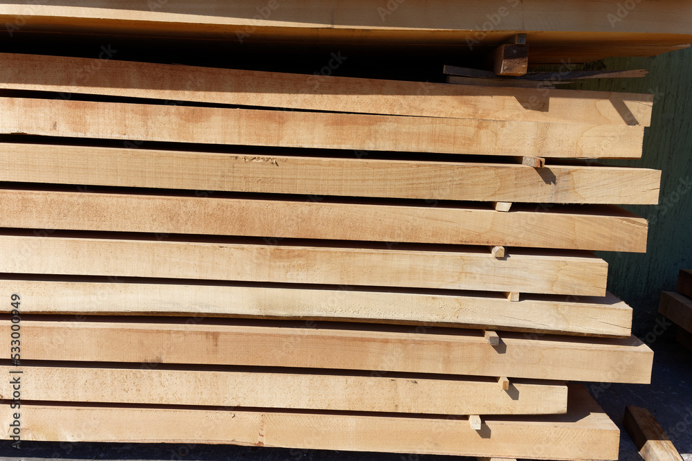 Wood texture.Stack of wood planks on lumber yard. lumber industrial wood texture timberwooden planks in close-up at a lumber warehouse. Background of boardsStack wooden studs, industrial wood lumber Wood texture.Stack of wood planks on lumber yard. lumber industrial wood texture timberwooden planks in close-up at a lumber warehouse. Background of boardsStack wooden studs, industrial wood lumber