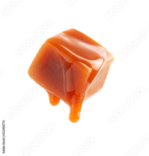 Falling caramel  candy with topping liquid closeup on white backgrounds.