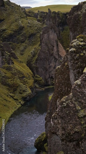 green valley  iceland  moss on the cliff  nature  vallue with stream  travel  scenic  wilderness 