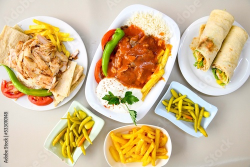 Table scene of assorted take out or delivery foods. Traditional Turkish cuisine. Various Turkish meal and appetizers. Top down view on a table. photo