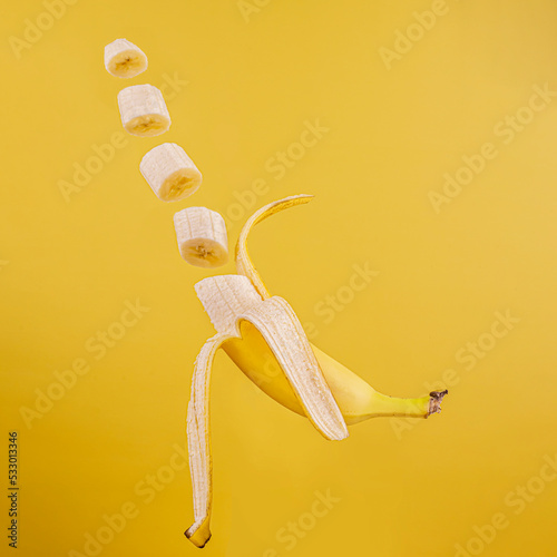 Floating half peeled banana and banana slices