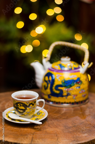 Darjeeling tea cup and traditional pot.