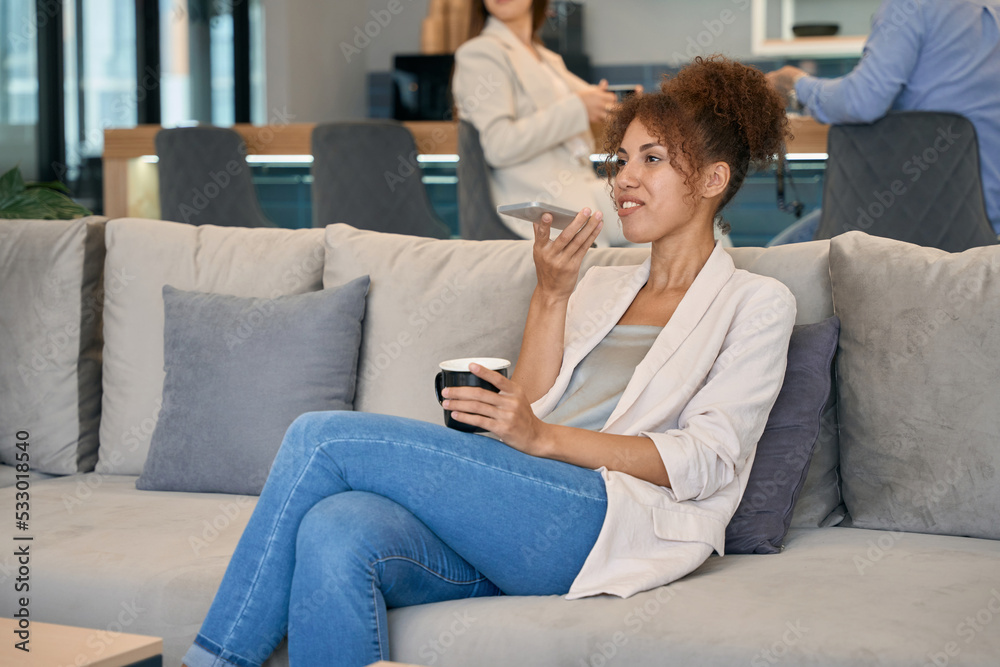 Woman talking on cellphone in co-working space Woman talking on cellphone in co-working space