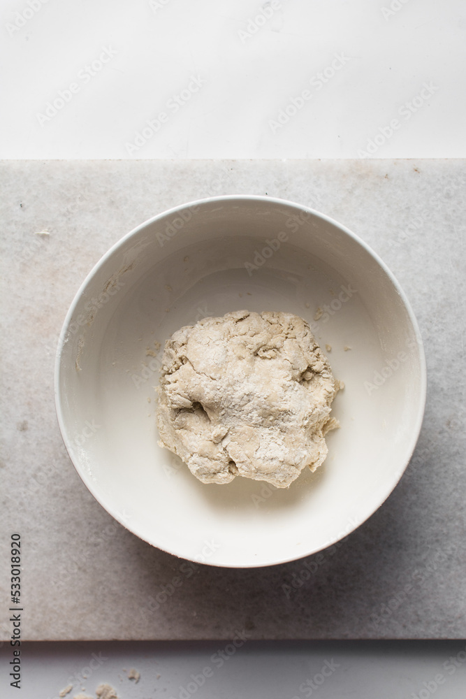 Dry noodles dough, homemade noodles, process of making noodles, dough in white bowl