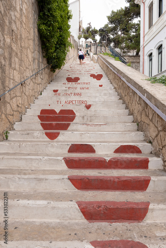 Vieste, Foggia, view of the stairs of love. Historic center, huge white stairs with red hearts of passion.