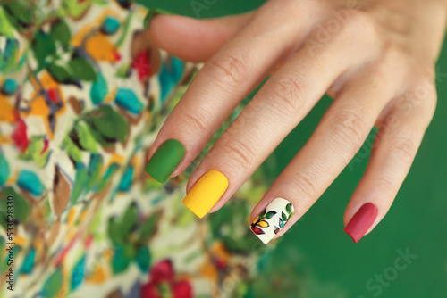 Multicolored manicure on square nails with floral design.