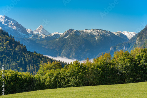 View to the Königssee covered with clouds. In the background the Steinerne Meer with the characteristic Schönfeldspitze 2653m above sea level. The Rocky Sea is a sub-range of the Berchtesgaden Alps photo