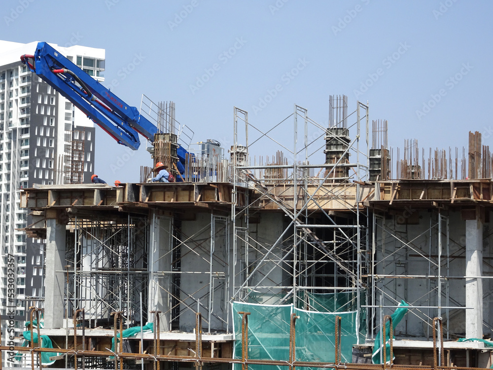 MELAKA, MALAYSIA -MAY 8, 2022: Temporary staircase made of steel and scaffolding that connects floor by floor. Used by construction workers. This ladder is wrapped with safety netting.