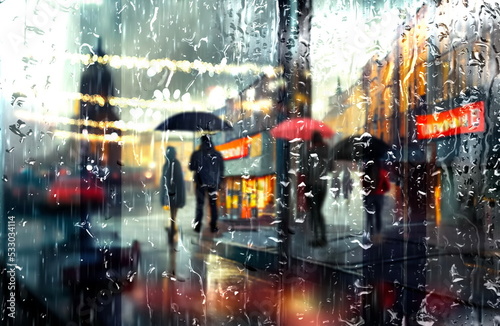 Fototapeta Naklejka Na Ścianę i Meble -   rain drops on window evening rainy city ,people walk with umbrellas blurred light urban city weather forecast background