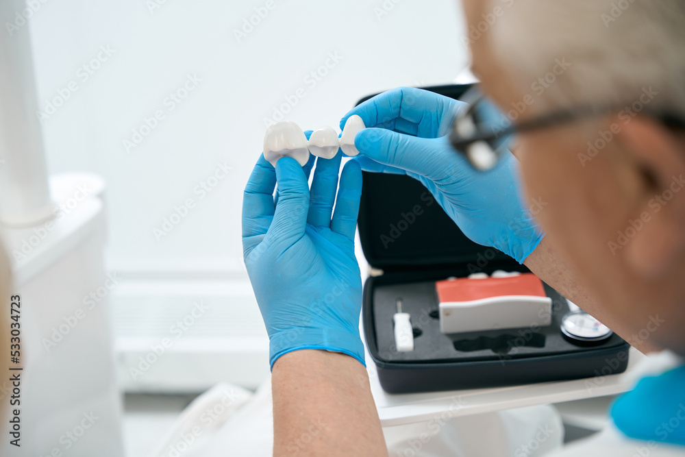 Dentist working in protective gloves in dental office Dentist working in protective gloves in dental office