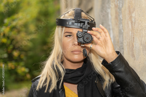 Girl with a night vision monocular close-up.