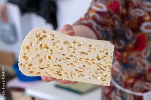 Homemade Caucasian cheese or Bryndza cut in slices at local market photo
