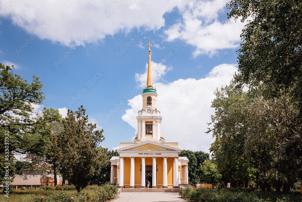 Church in the park in Ukraine among the crowns of trees. High quality photo
