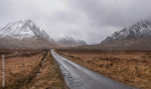 Dark and moody Winter landscape image of Lost Valley Etive Mor in Scottish Highlands wirth dramatic clouds overhead