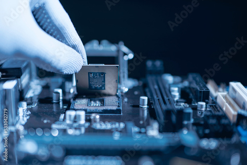 Repairman computer Installation CPU on socket of the motherboard. Computer technology and hardware maintenance or repair.