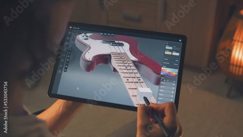Slika na platnu Man working at home remotely and creating 3D prototype of guitar in professional