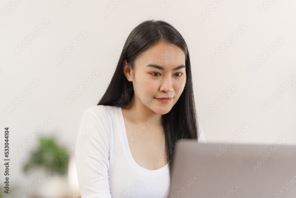 Happy smart asian woman freelancer working with laptop while live in the room. Happy smart asian woman freelancer working with laptop while live in the room.