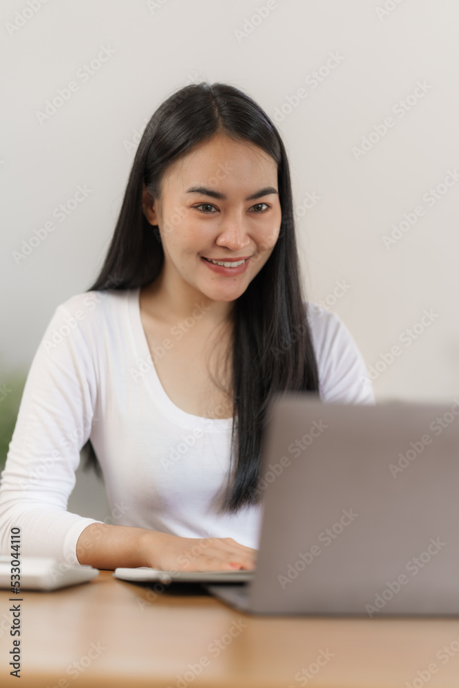 Happy smart asian woman freelancer working with laptop while live in the room. Happy smart asian woman freelancer working with laptop while live in the room.
