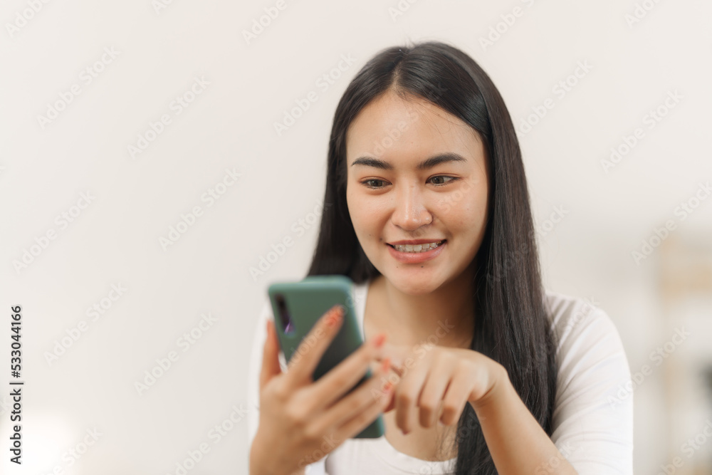 Portrait of smile asian woman freelancer using mobile phone at home office. Portrait of smile asian woman freelancer using mobile phone at home office.