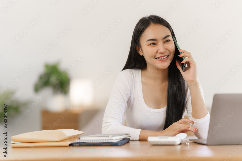 Attractive asian woman using personal smartphone voice calling app indoors.