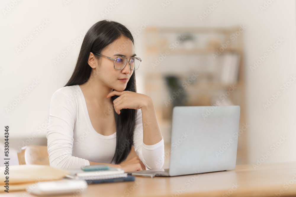 Happy smart asian woman freelancer working with laptop while live in the room. Happy smart asian woman freelancer working with laptop while live in the room.