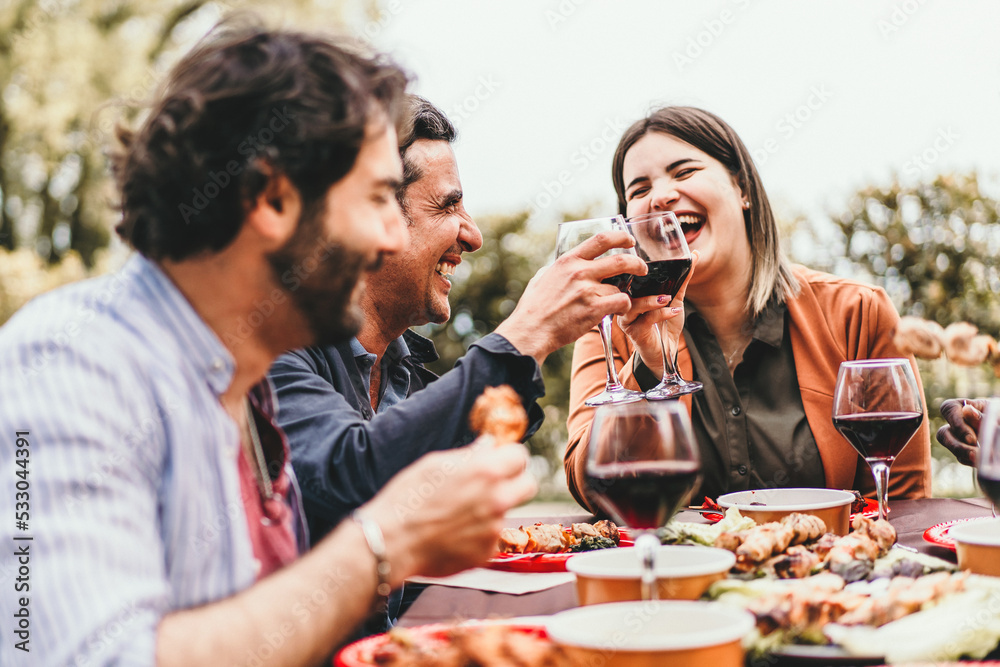 A group of friends meet on the weekend eating grilled meat and drinking ...