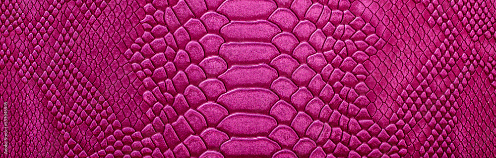 Obraz premium Beautiful red, pink bright snake or crocodile skin, reptile skin texture, multicolored close-up as a background.