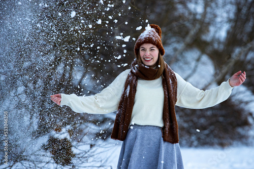 Canvastavla sweet girl in woollen hat, jumper, black skirt and tights enjoys the freezing co