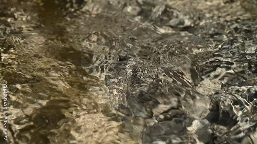 Closeup of water from a mountain river in summer (slow motion) Closeup of water from a mountain river in summer (slow motion)
