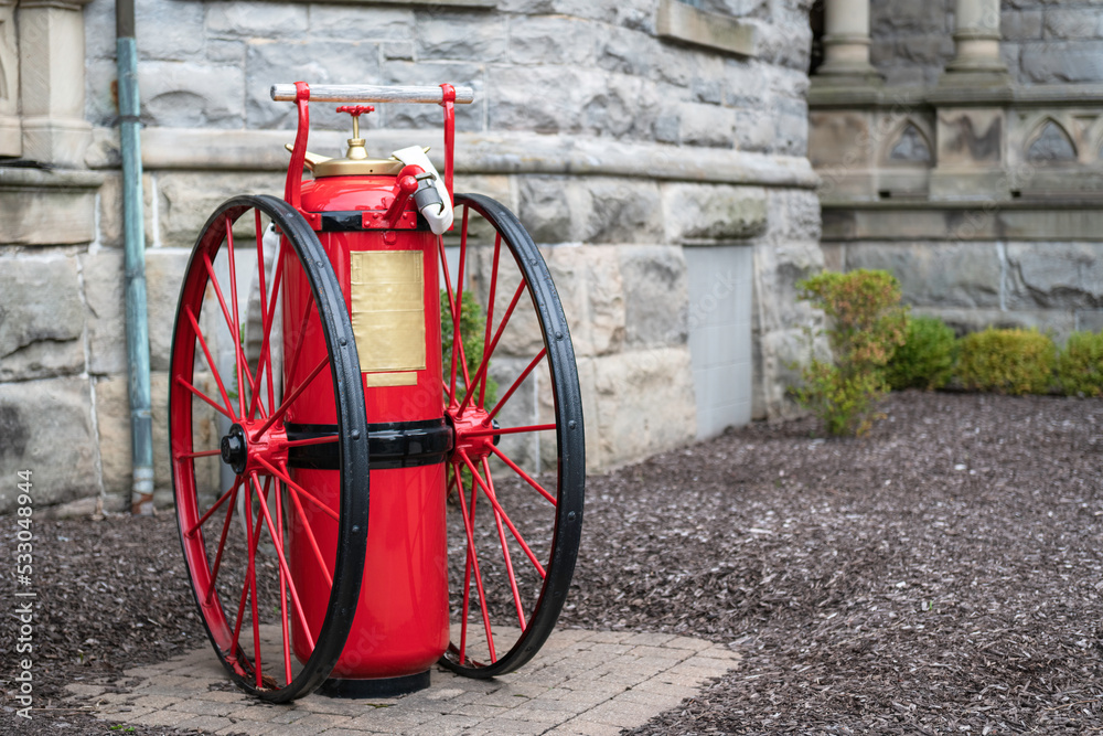 Large antique fire extinguisher on wheels Stock Photo | Adobe Stock