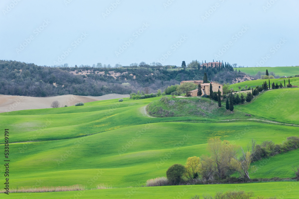 View of a farm upon the green hills of the Tuscany countryside,  Italy