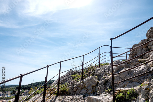 Protective metal railing on stone slope