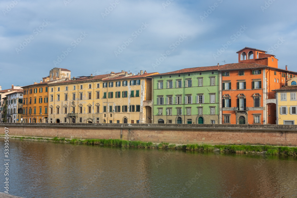 Pisa, Italy,  14 April 2022: View of the colorful banks of Arno river