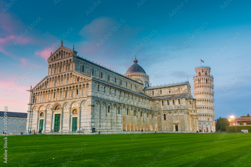 Pisa, Italy,  14 April 2022: Cathedral and leaning tower at sunset