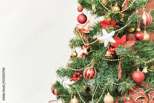 Home Christmas tree with ornaments in traditional colors  red  green and gold. Composition with copy space.