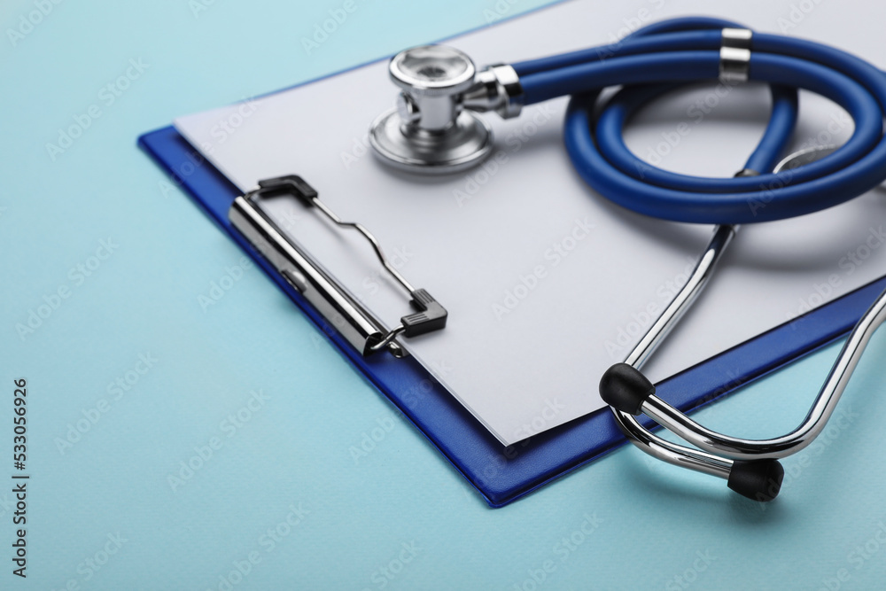 Clipboard with stethoscope on turquoise background, closeup. Space for text Clipboard with stethoscope on turquoise background, closeup. Space for text