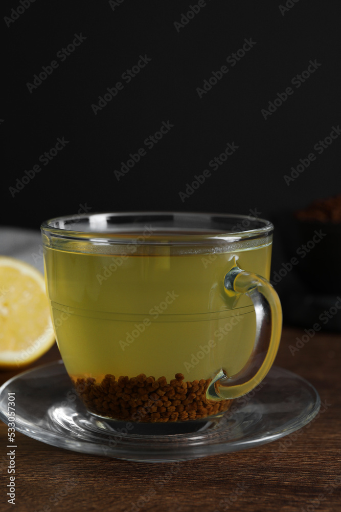 Buckwheat tea in cup on wooden table, closeup Buckwheat tea in cup on wooden table, closeup