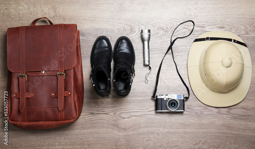 Flat lay composition with different safari accessories on wooden background