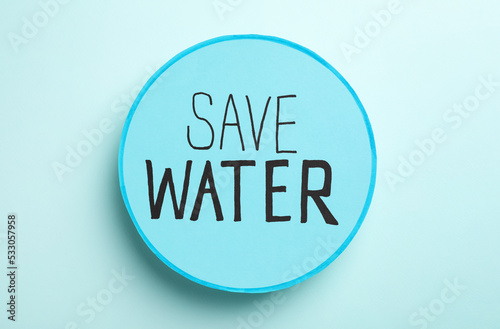 Quadro su tela Card with words Save Water on light blue background, top view