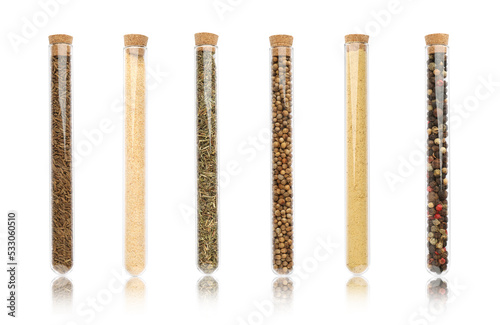 Set of glass tubes with different spices on white background