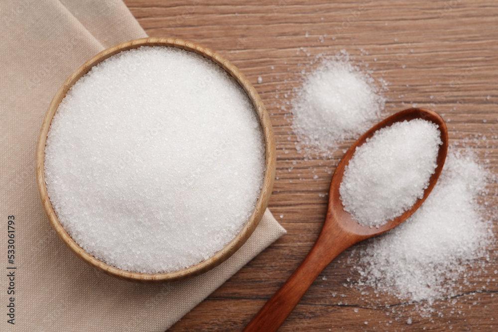 Granulated sugar on wooden table, flat lay Granulated sugar on wooden table, flat lay