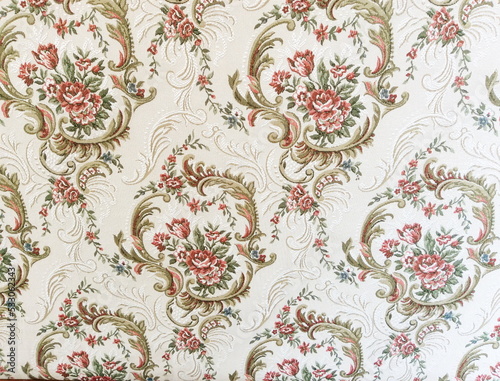 Fragment of colorful retro tapestry textile pattern with floral ornament useful as background