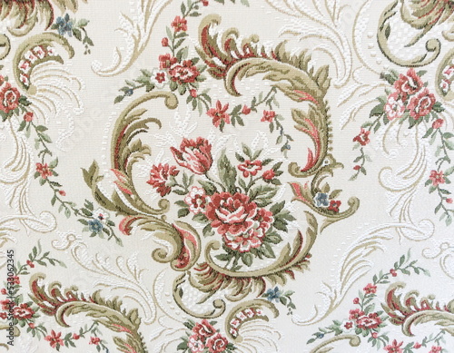 Fragment of colorful retro tapestry textile pattern with floral ornament useful as background