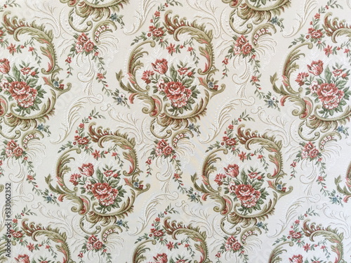 Fragment of colorful retro tapestry textile pattern with floral ornament useful as background