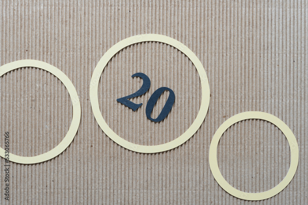 the number 20 with yellow paper rings on corrugated paper the number 20 with yellow paper rings on corrugated paper