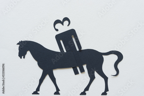 stick figure dingbat with the number 3 for a head on an equally stylized  elongated  horse on blank paper